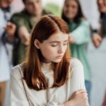 cropped view of group of teenagers bullying girl