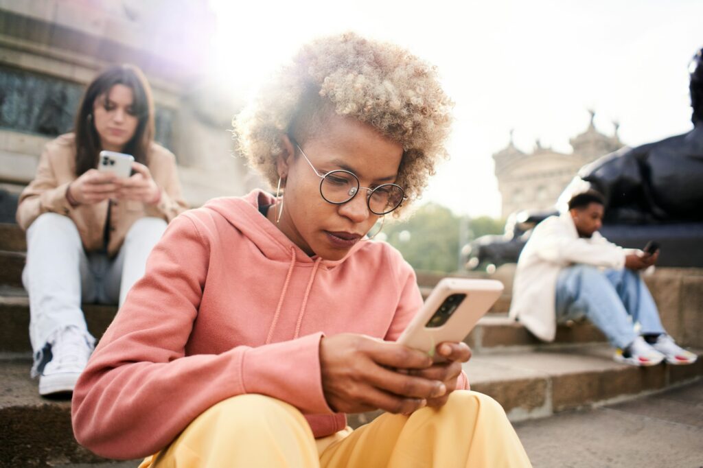 Group of people ignoring each other using phone with serious face