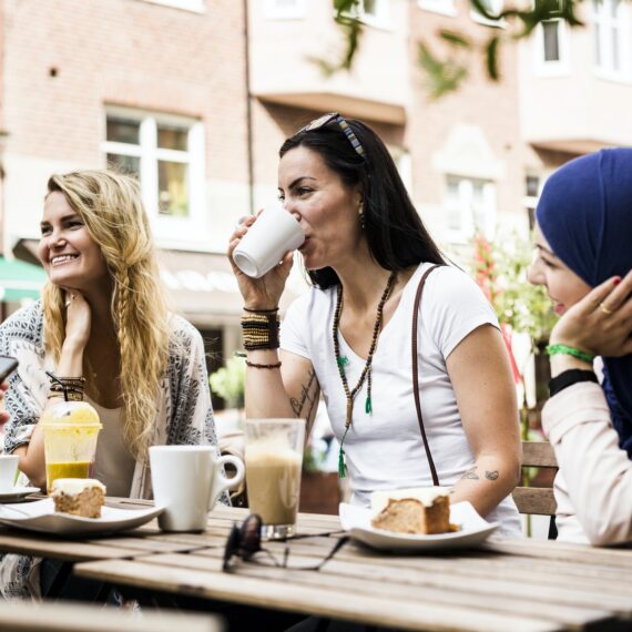 Group of people sitting at outdoor cafe table