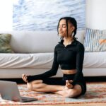 Meditation, relaxation concept. Calm african american girl in sportswear, takes care of health