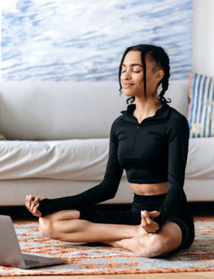 Meditation, relaxation concept. Calm african american girl in sportswear, takes care of health