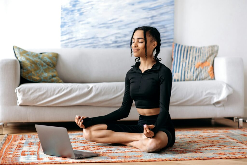 Meditation, relaxation concept. Calm african american girl in sportswear, takes care of health