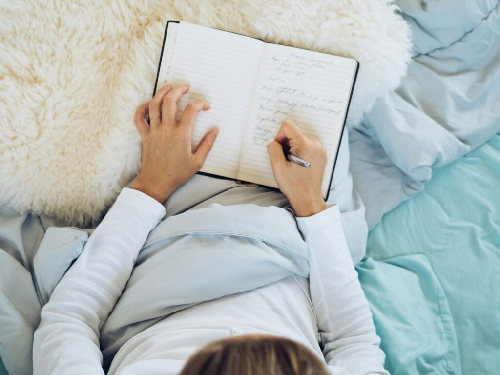 Woman journaling in bed