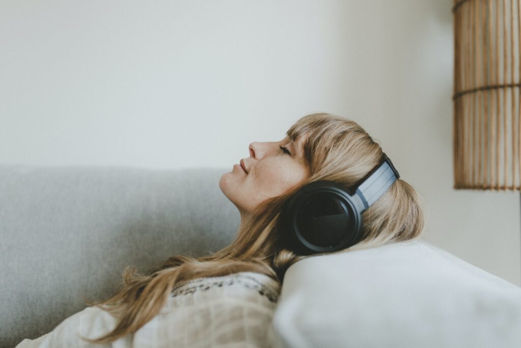 Woman listening to music, white tone