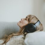 Woman listening to music, white tone