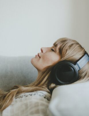 Woman listening to music, white tone