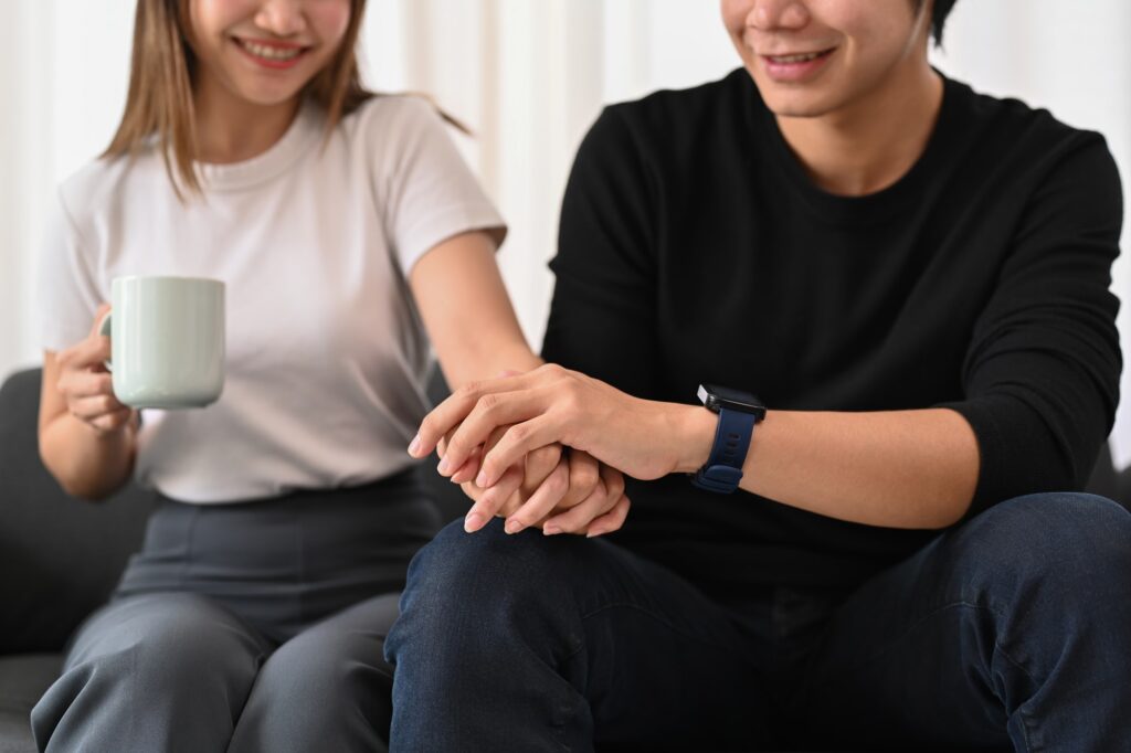 Young couple hold hands, showing love and care. Concept of expressing love feelings