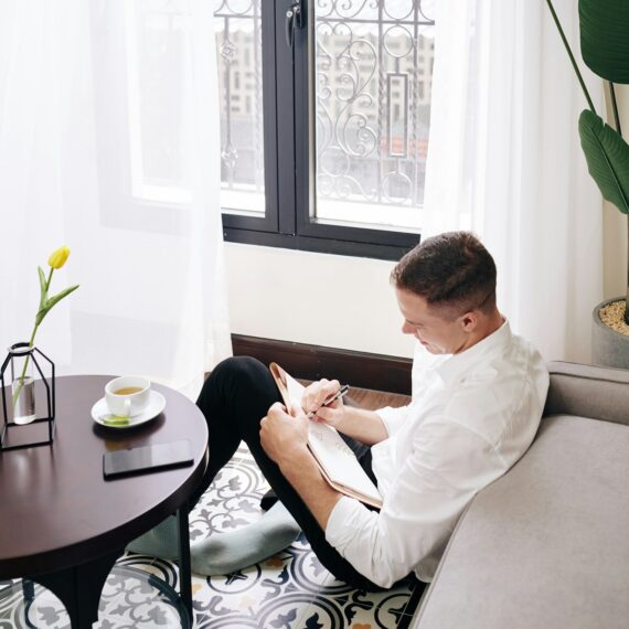 Young man filling gratitude journal