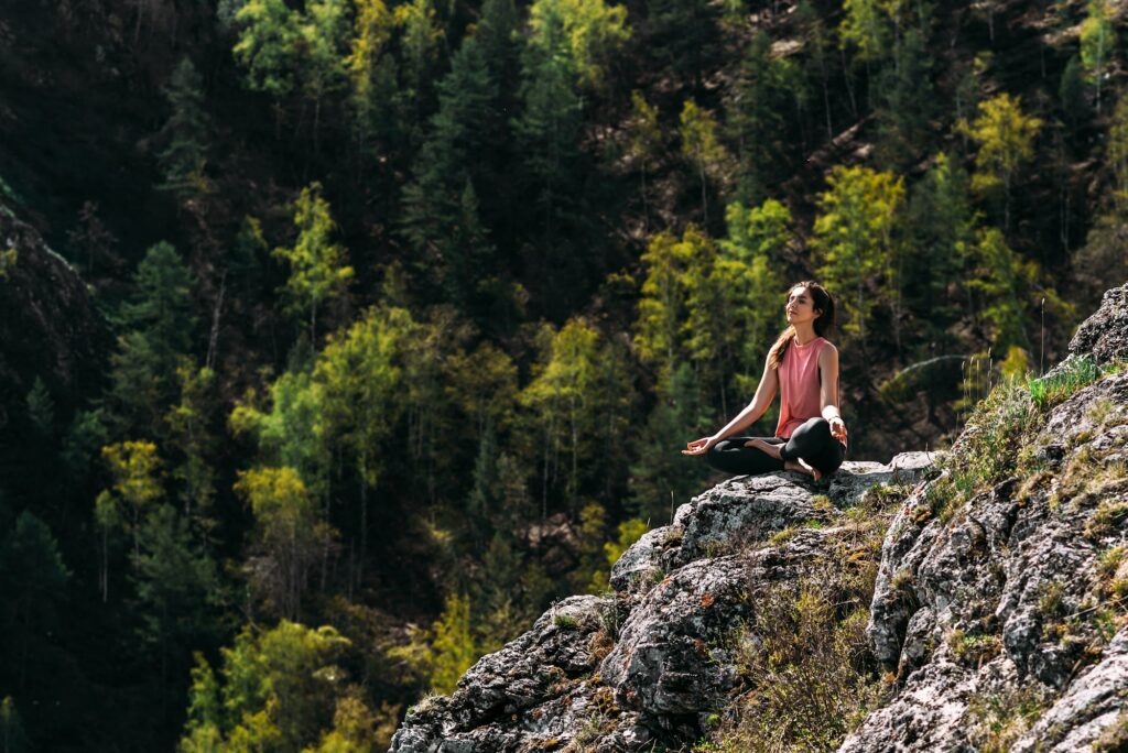 Attractive woman doing yoga. Healthy lifestyle. Woman doing yoga in the mountains.