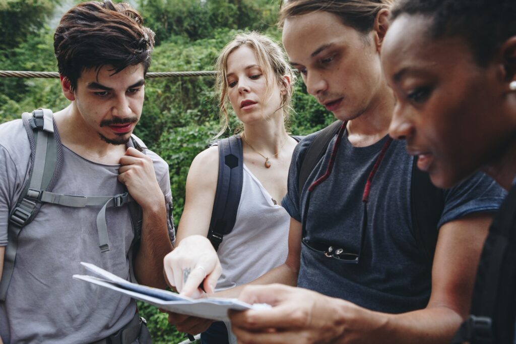 Friends lost in nature with a map