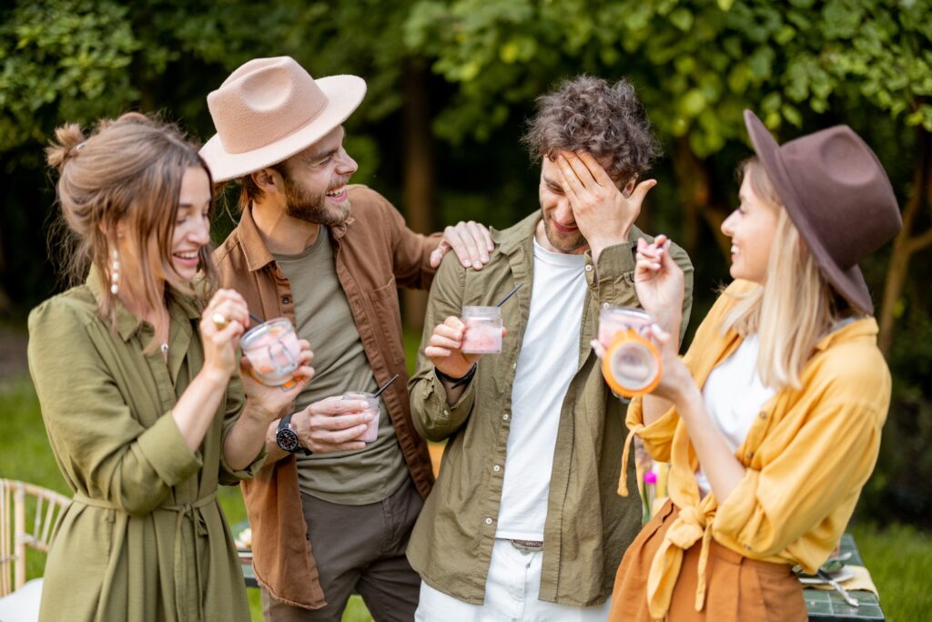 Friends with ice cream gathering outdooors