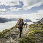 Rear view of female hiker hiking alongside Grey glacier lake, Torres del Paine National Park, Chile