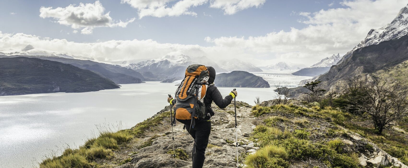 Rear view of female hiker hiking alongside Grey glacier lake, Torres del Paine National Park, Chile