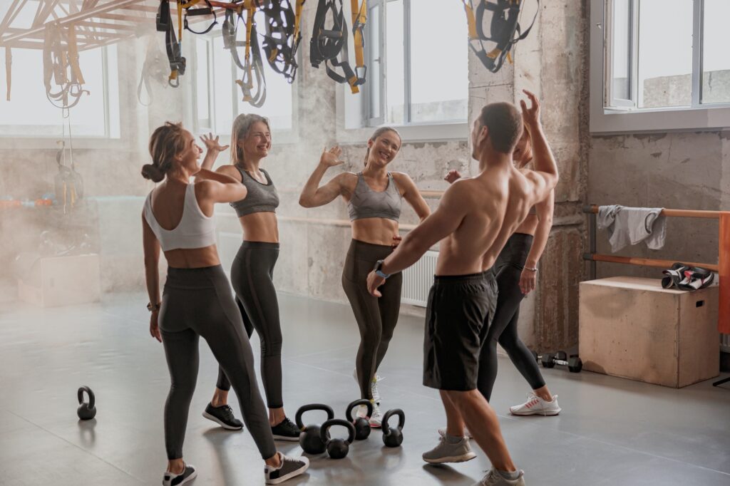 Team of young people training in gym club