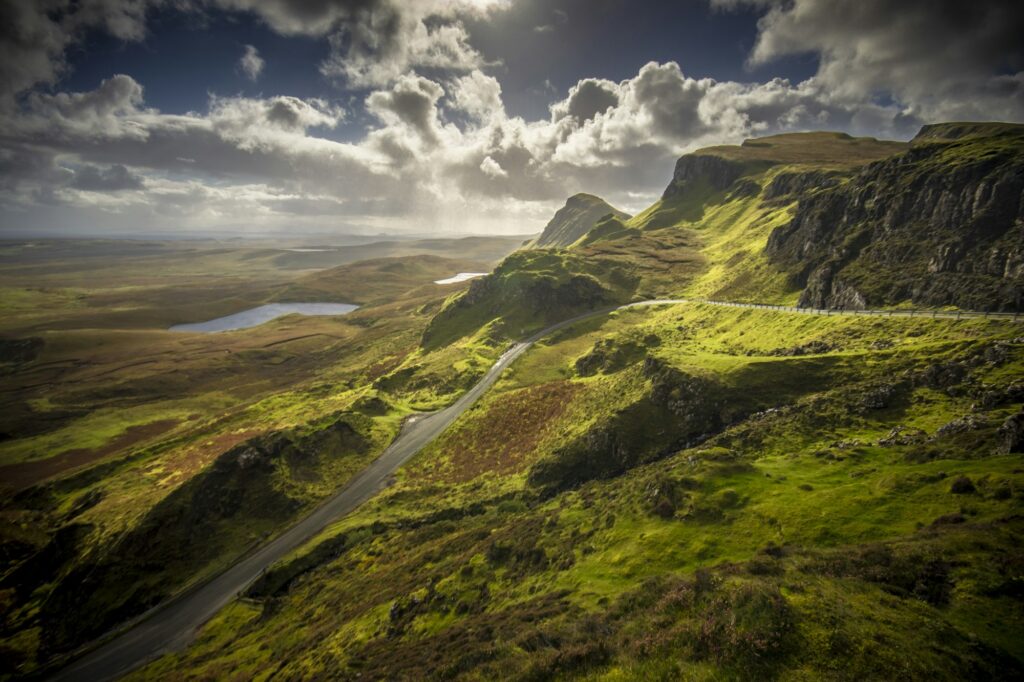 Aerial shot of the Quiraing in the Isle of Skye in Scotland under a cloudy blue sky