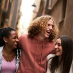 Group Of Happy Friends Having Fun Together Outdoors. Mixed race people laughing making community.