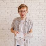 man reading a surprising fact in the book.