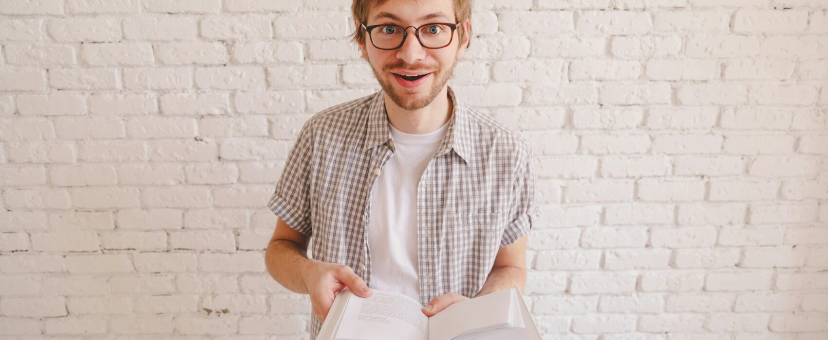 man reading a surprising fact in the book.