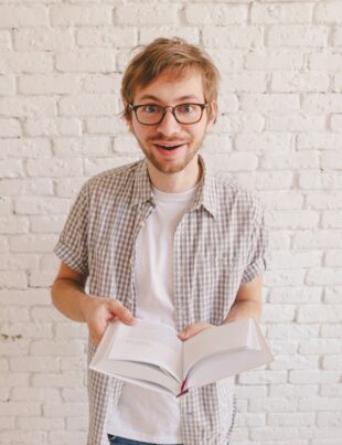 man reading a surprising fact in the book.