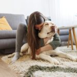 Woman cuddling and hugging her pet dog